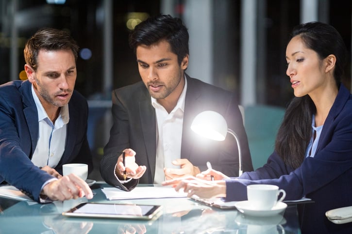 Group of businesspeople discussing over digital tablet in the office.jpeg