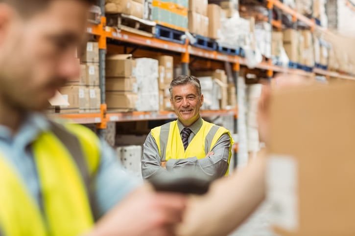 Warehouse worker scanning barcode on box in a large warehouse.jpeg
