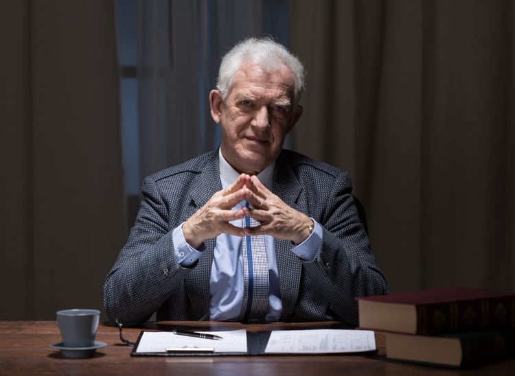 Senior businessman sitting at the office desk